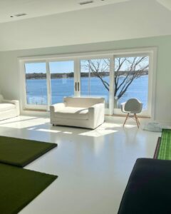 High-quality glass windows and doors showcasing a stunning lakeside view, highlighting the craftsmanship and design possibilities of custom glasswork.
