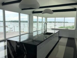 Modern kitchen with stylish glass countertops, showcasing a sleek and contemporary design overlooking a waterfront view.Modern kitchen with stylish glass countertops, showcasing a sleek and contemporary design overlooking a waterfront view.