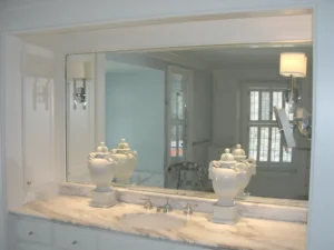 Modern bathroom vanity featuring a large rectangular LED backlit mirror for a luxury look