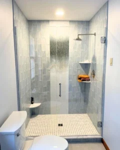 A swing door custom glass shower enclosure