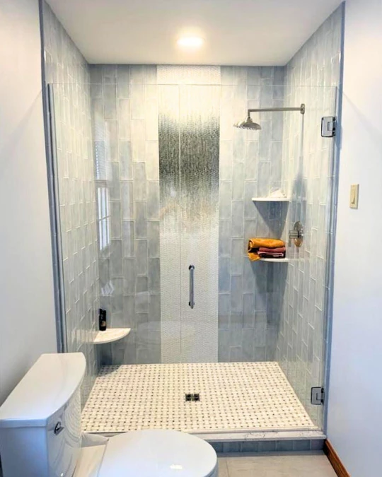 A swing door custom glass shower enclosure