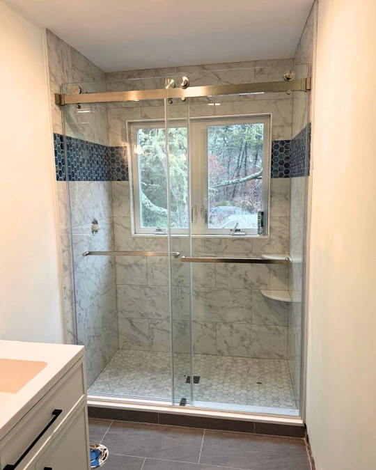 custom shower glass enclosure that keeps your bathroom bright and open.