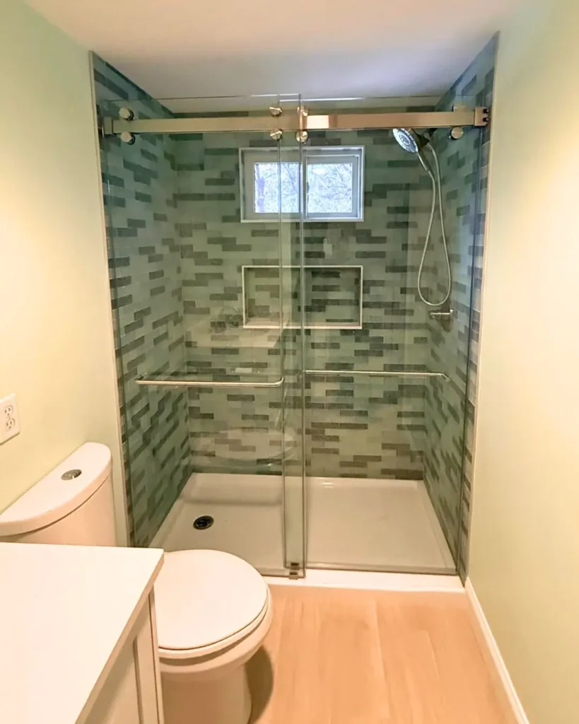 Sliding frameless glass shower enclosure with roller hardware installed in Wellfleet MA