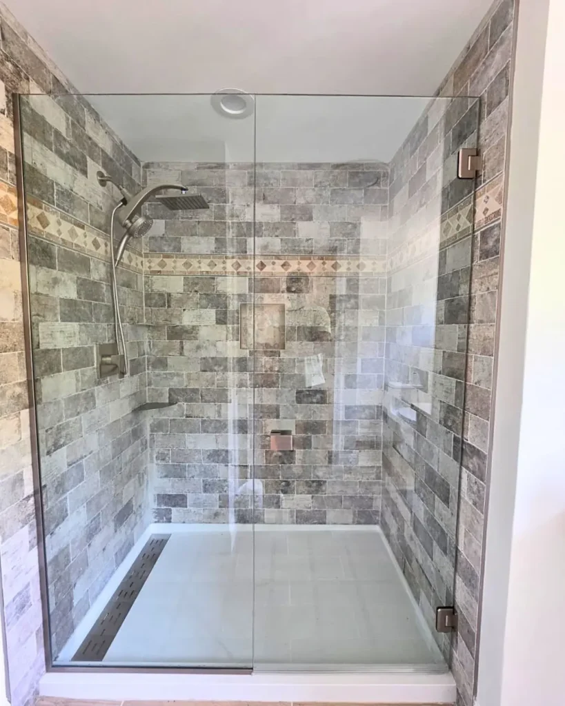 Custom stand-in frameless glass shower enclosure with brushed nickel hardware in Cotuit MA